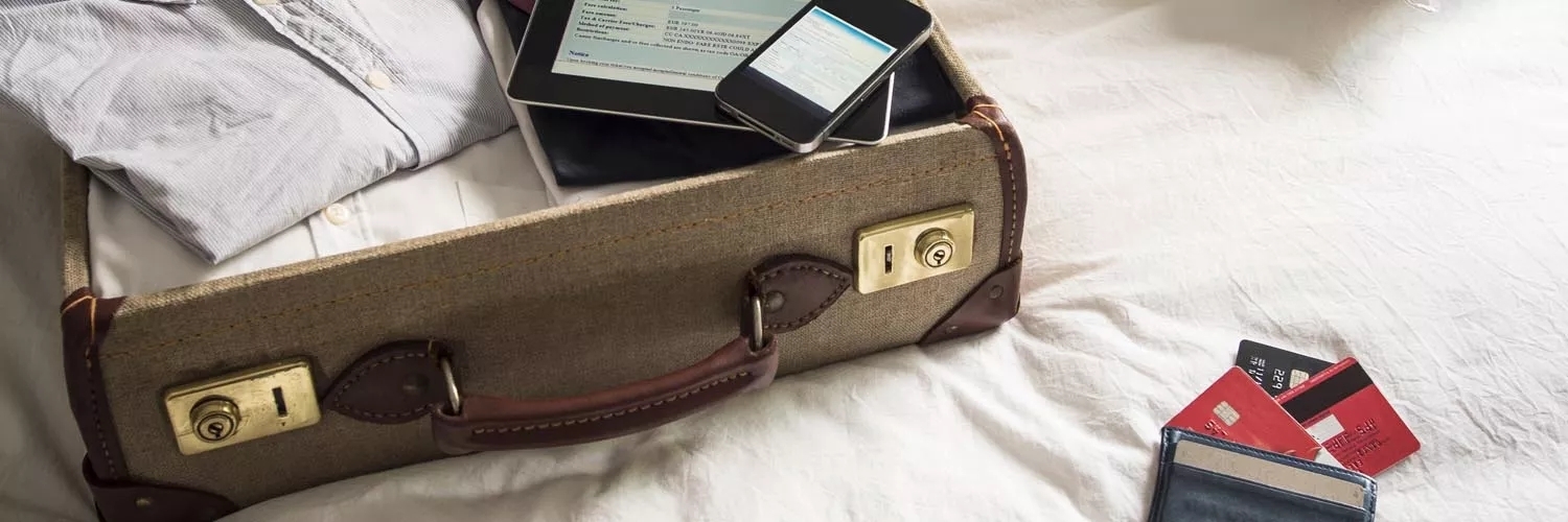An opened, classic, stitched briefcase seemingly prepared for business travel.