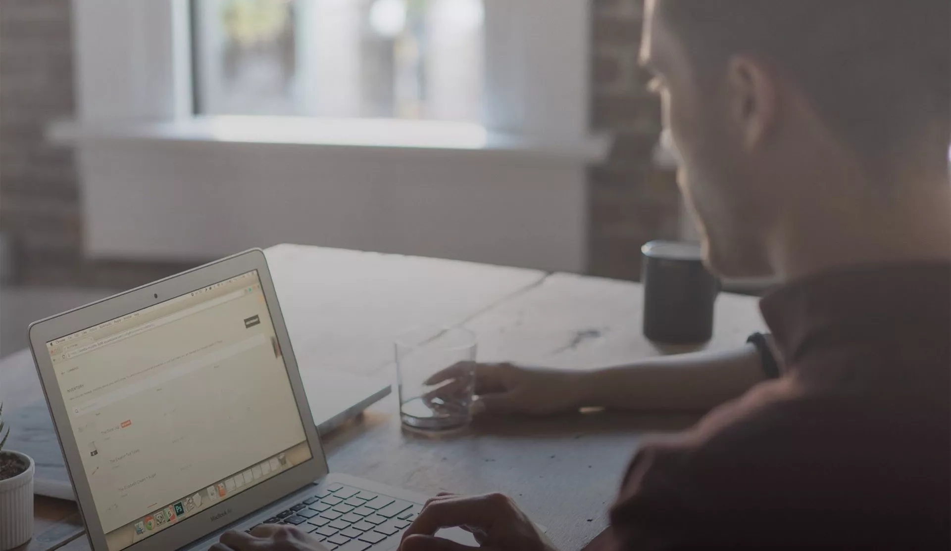 Viewing a discussion around a laptop in front of this person on a wooden table.