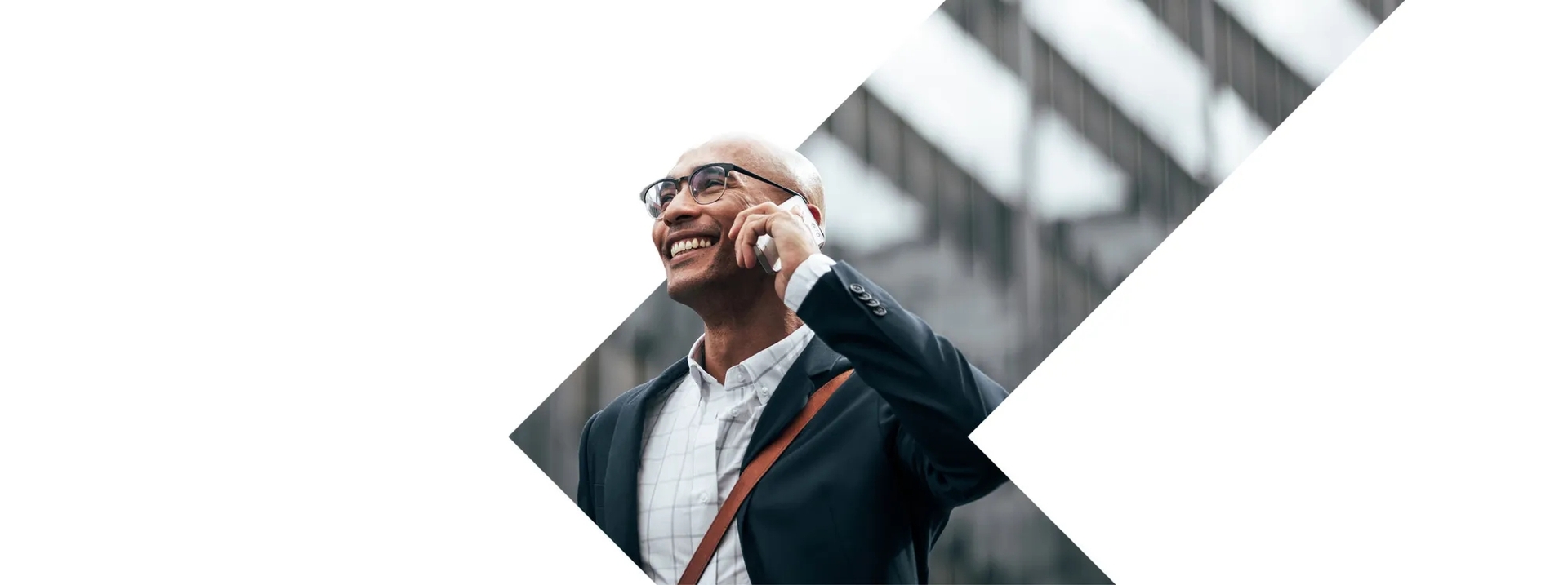 A man standing in front of building talking on the phone A man standing in front of building talking on the phone