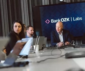 Bank OZK leadership discussing in a meeting room at Bank OZK Innovation Labs.