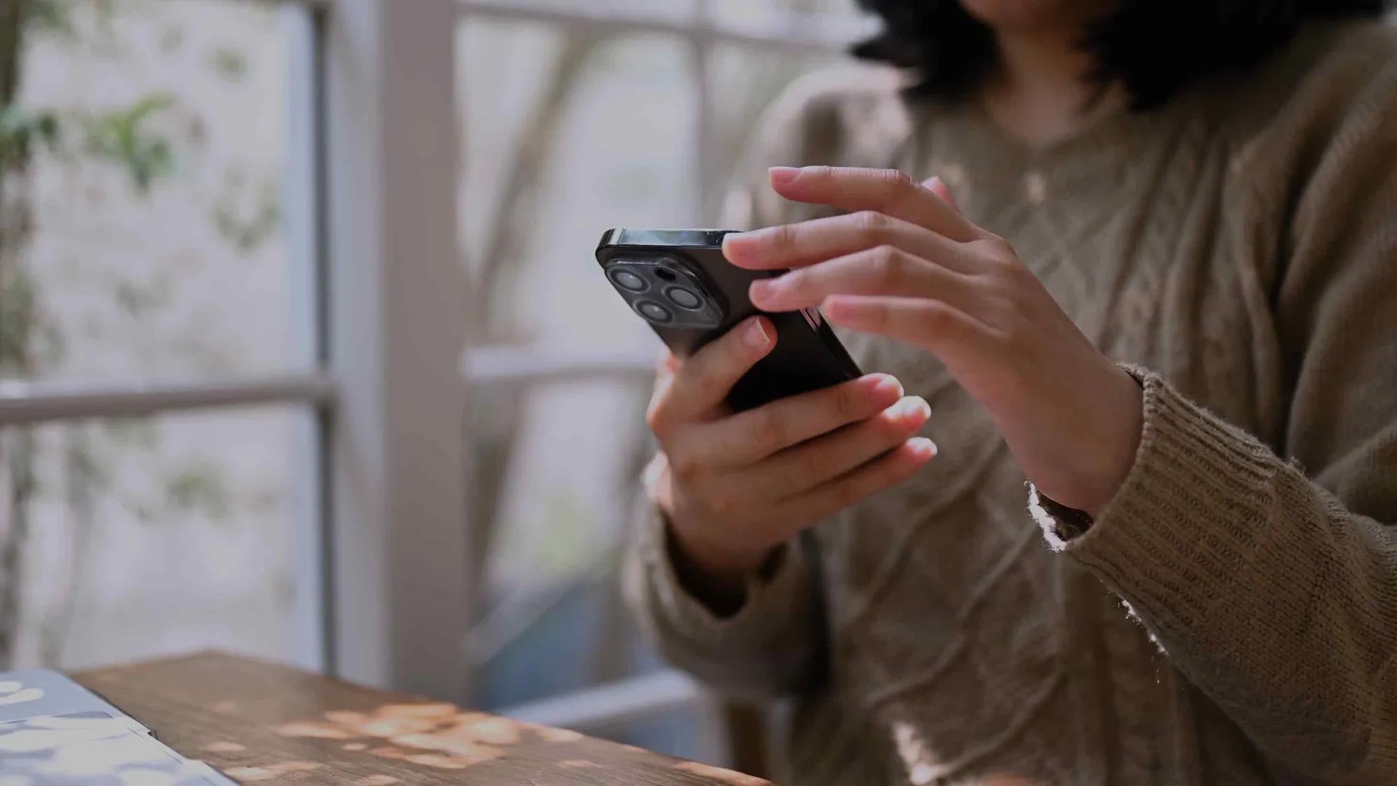 A woman holding a phone. A woman holding a phone.