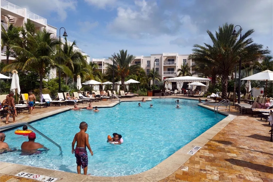 Kids playing in an outdoor resort pool.